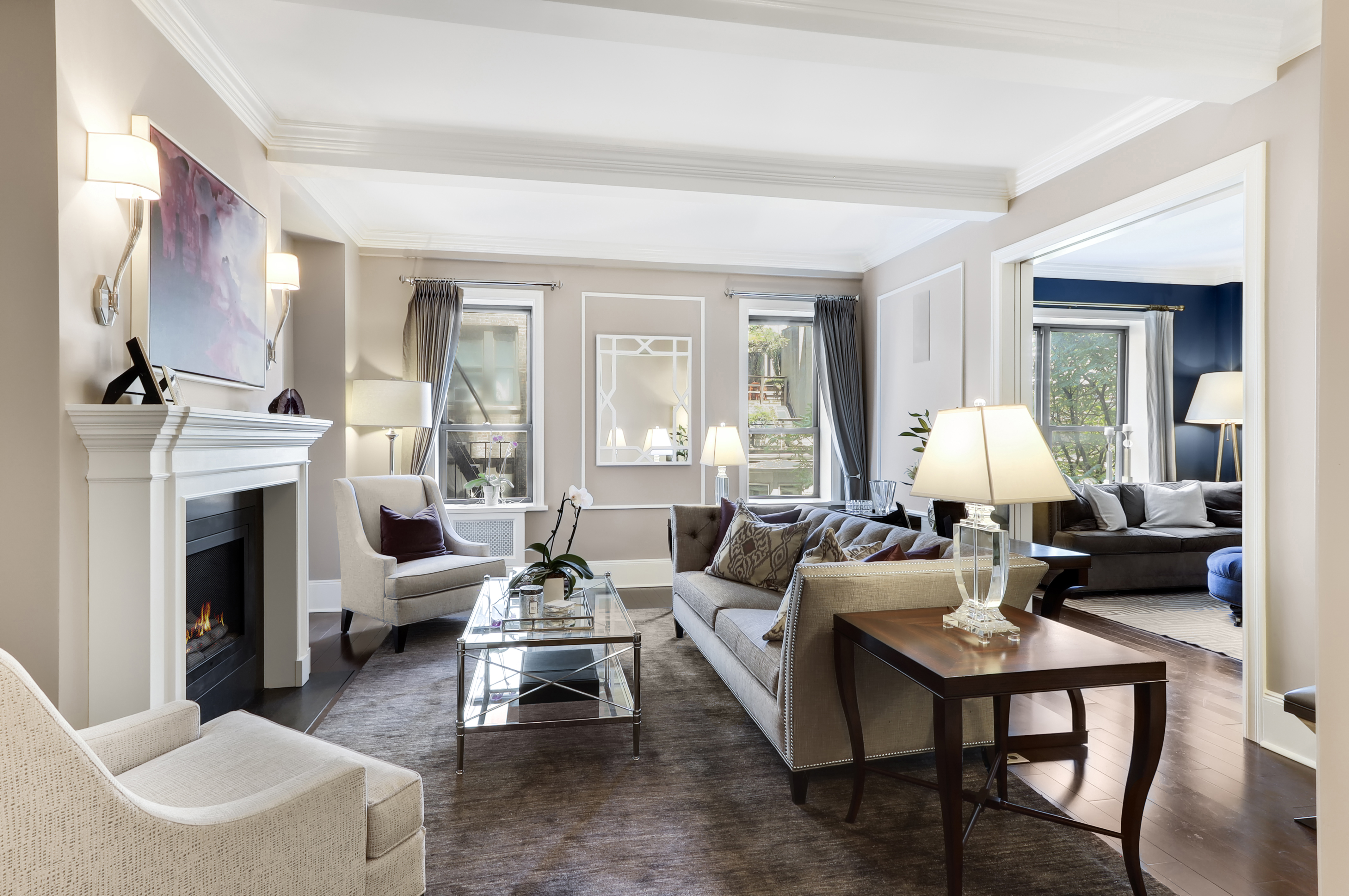 a living room with furniture fireplace and a large window