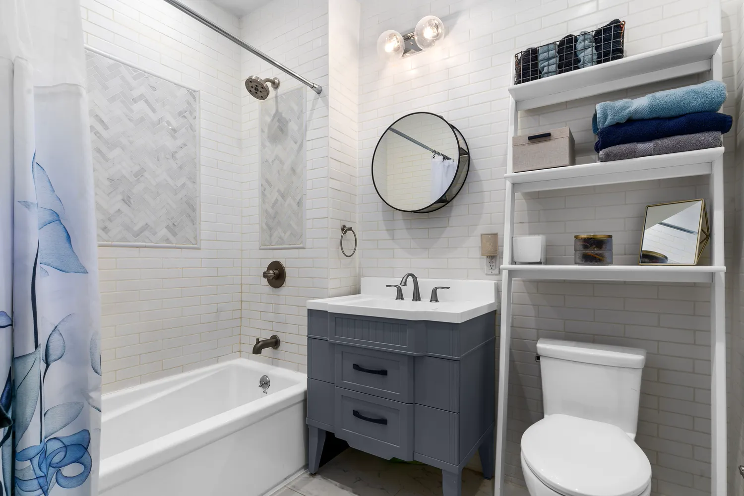 a bathroom with a toilet a sink a mirror a bathtub and vanity