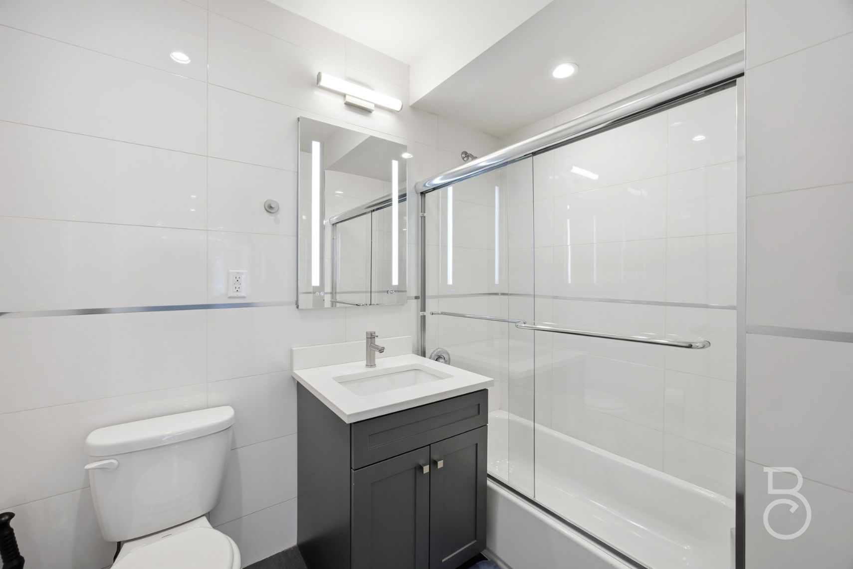 23-23 30th Road, Unit 3A Queens, NY 11102 - Photo 5 of 15 a bathroom with a toilet sink and mirror