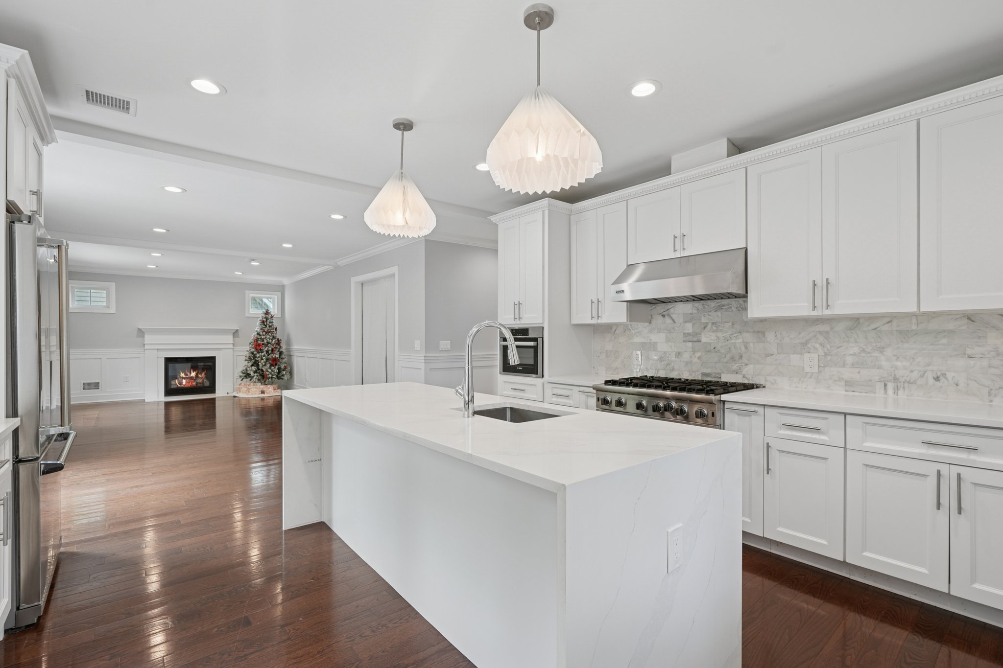 823 River Road Chatham, NJ 07928 - Photo 12 of 60 a kitchen with a stove a refrigerator a sink dishwasher with a dining table and chairs with wooden floor