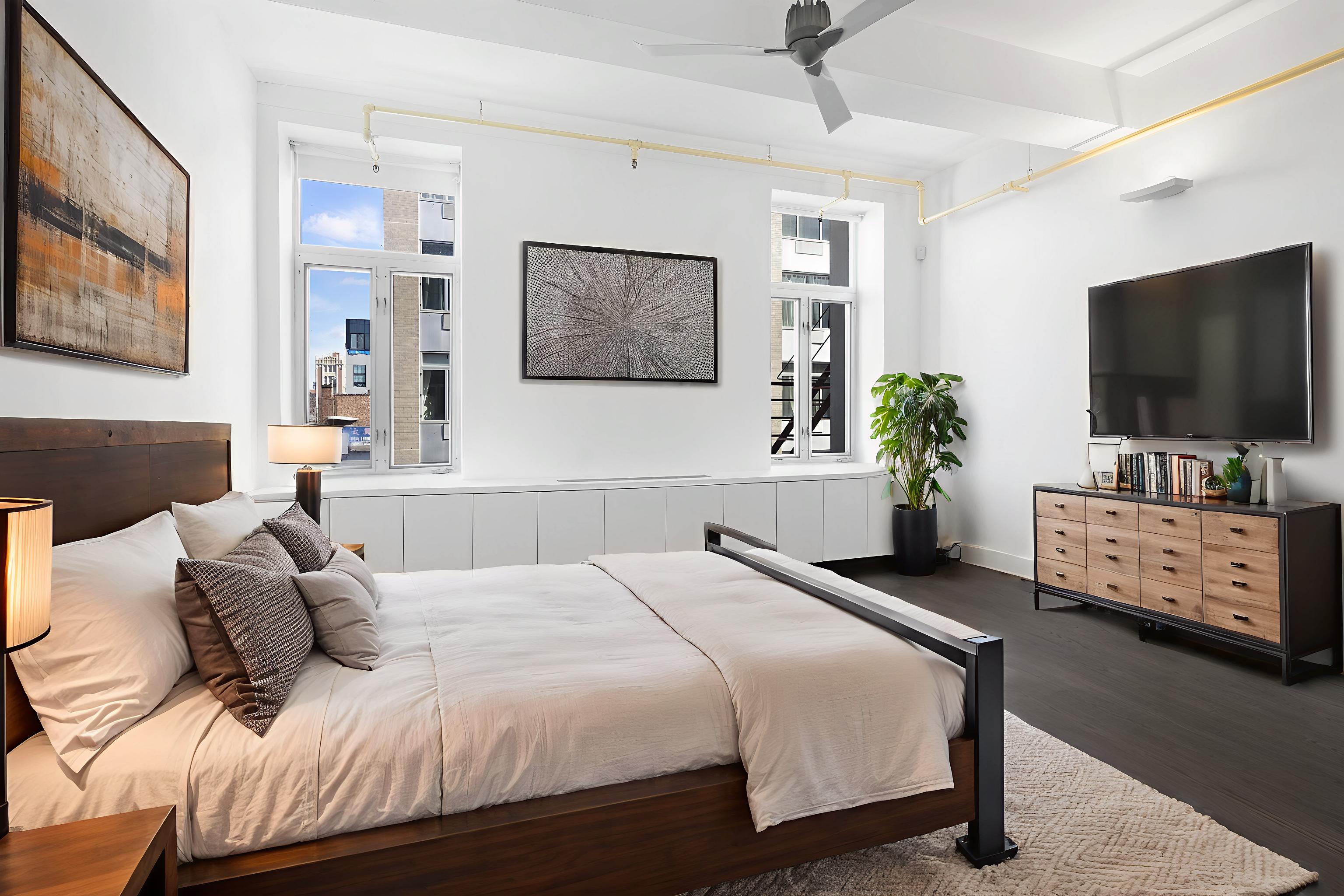 91 Grand Avenue, Unit 2D Brooklyn, NY 11205 - Photo 7 of 16 a bedroom with a bed and a flat screen tv