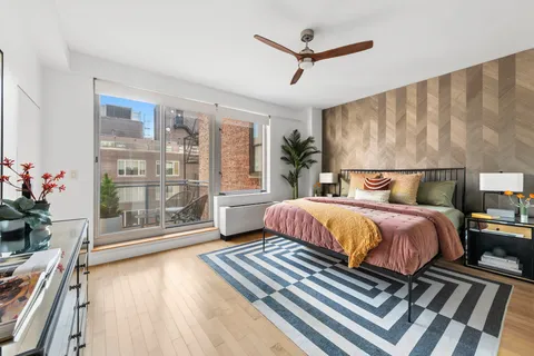 a bedroom with a large bed and a chandelier