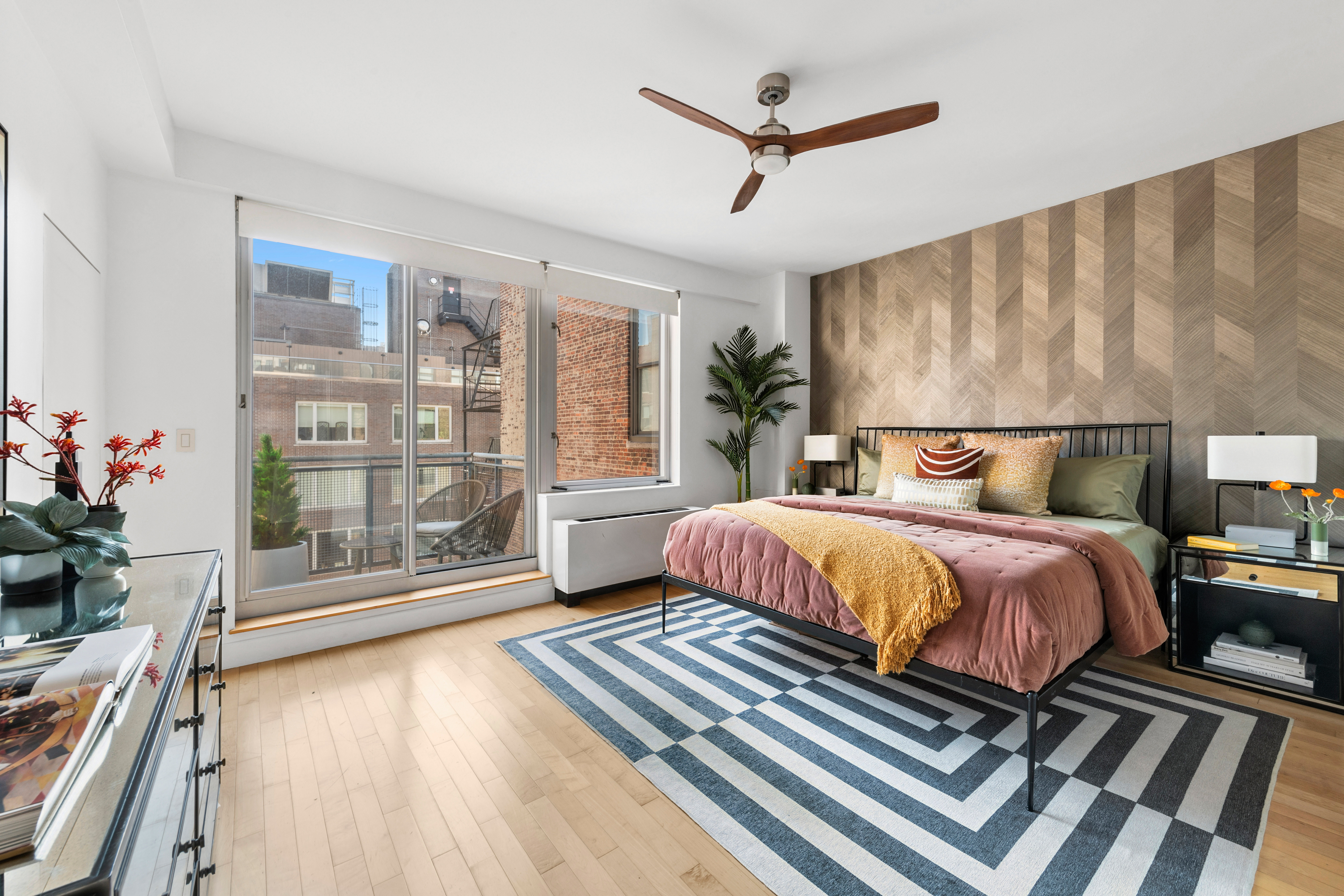 146-148 West 22nd Street, Unit PH Manhattan, NY 10011 - Photo 5 of 13 a bedroom with a large bed and a chandelier