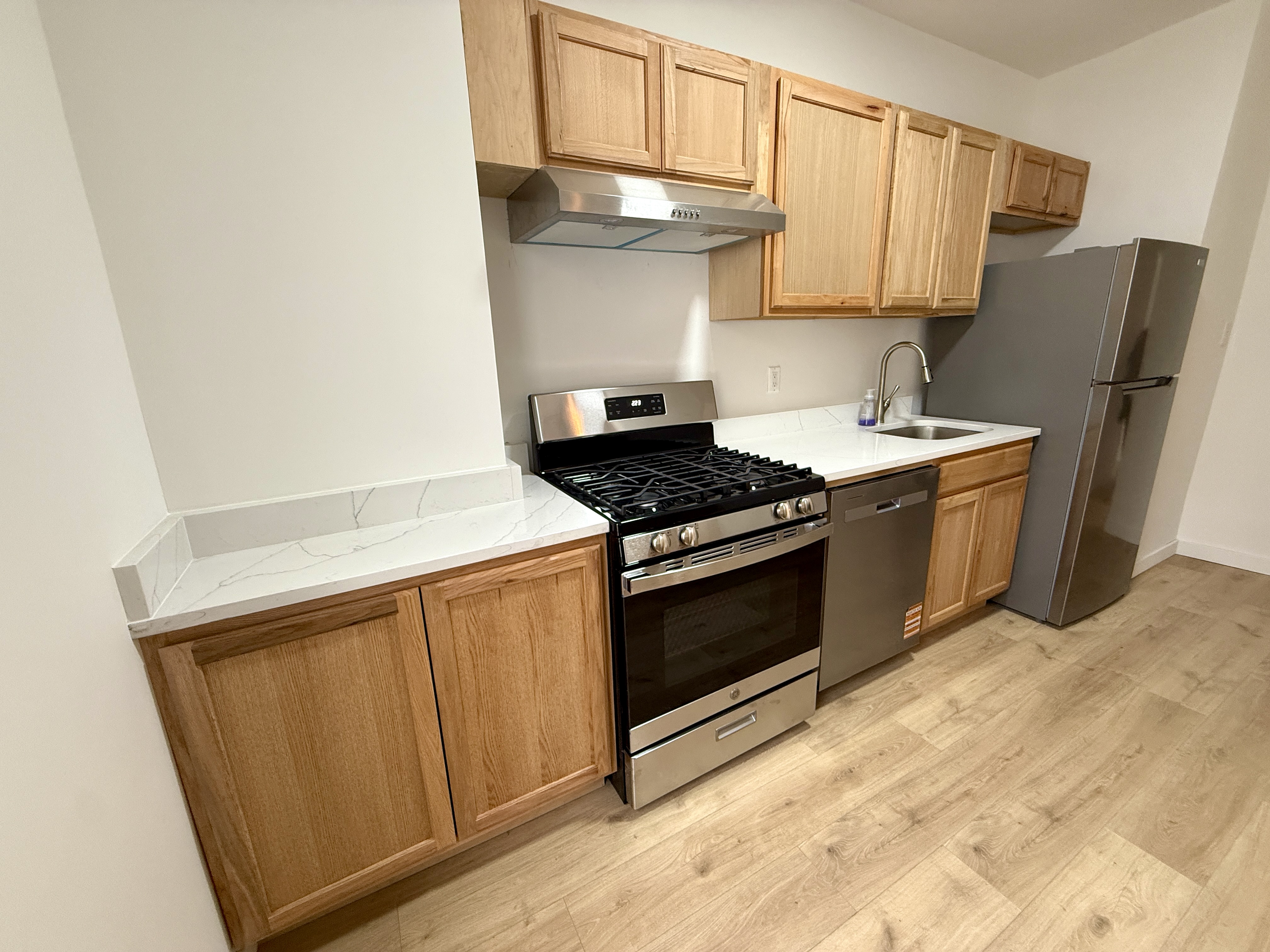 31 Seeley Street, Unit Undisclosed Brooklyn, NY 11218 - Photo 10 of 31 a kitchen with stainless steel appliances a refrigerator stove and cabinets