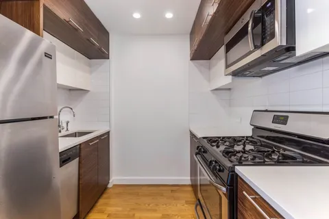 a kitchen with stainless steel appliances granite countertop a stove and a microwave