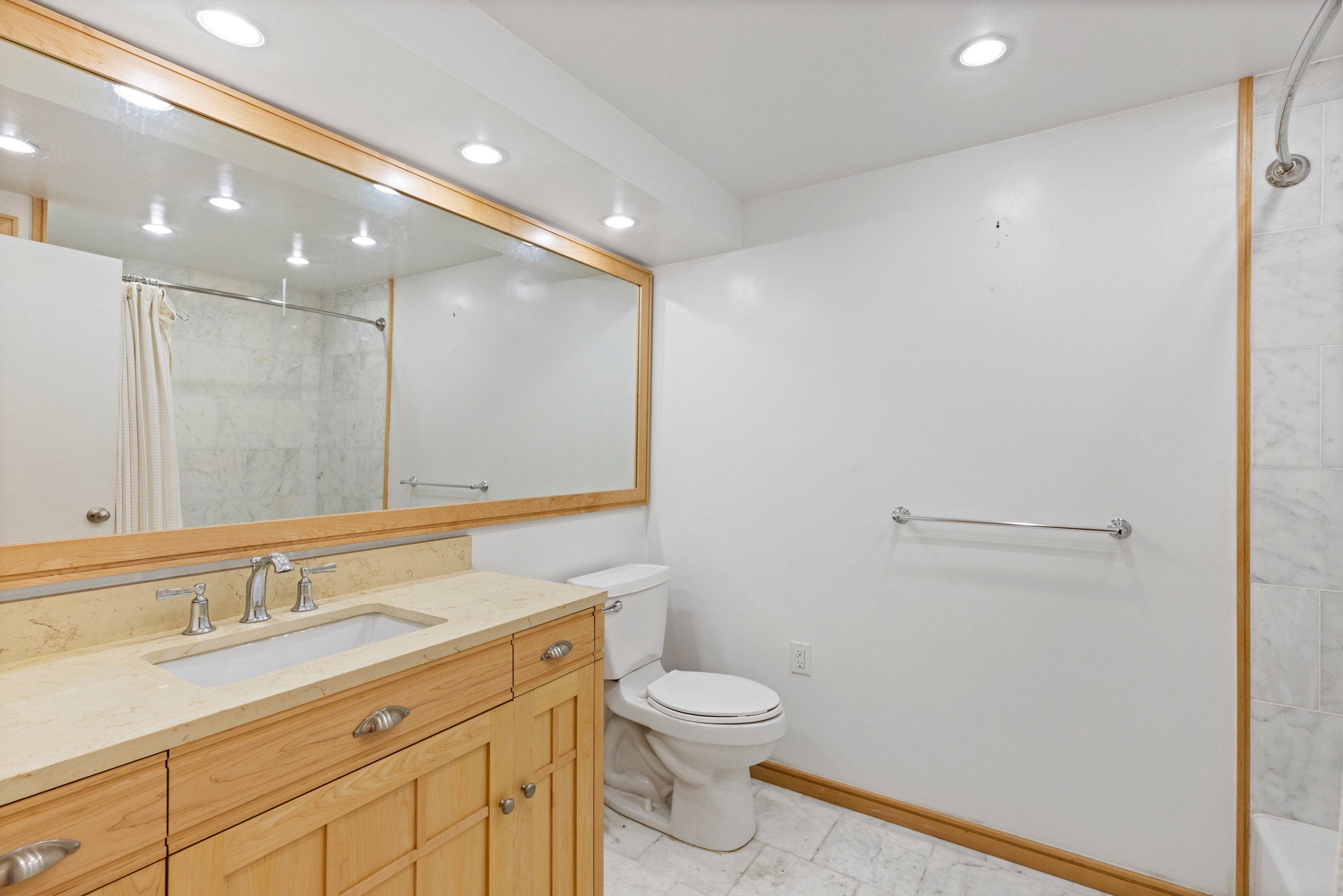 136 East 30th Street, Unit DUPLEX Manhattan, NY 10016 - Photo 20 of 26 a bathroom with a granite countertop sink a toilet and a shower