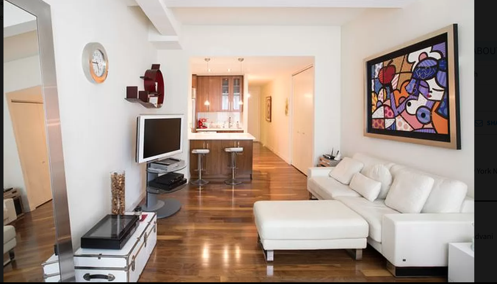 88 Greenwich Street, Unit 911 Manhattan, NY 10006 - Photo 2 of 10 a living room with furniture a flat screen tv and a wall