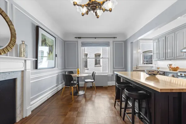 a kitchen with stainless steel appliances granite countertop a stove a refrigerator a sink a stove and island with wooden floor