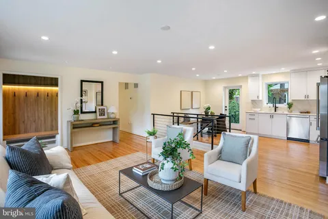 a living room with furniture kitchen view and a table