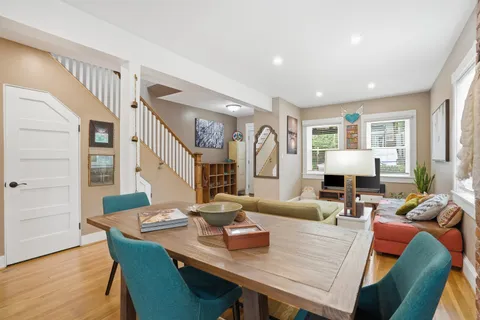 a view of a dining room with furniture and wooden floor