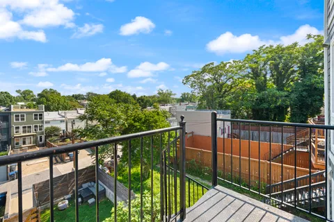 a view of balcony with wooden floor and fence