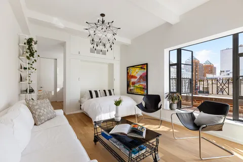 a living room with furniture and a chandelier
