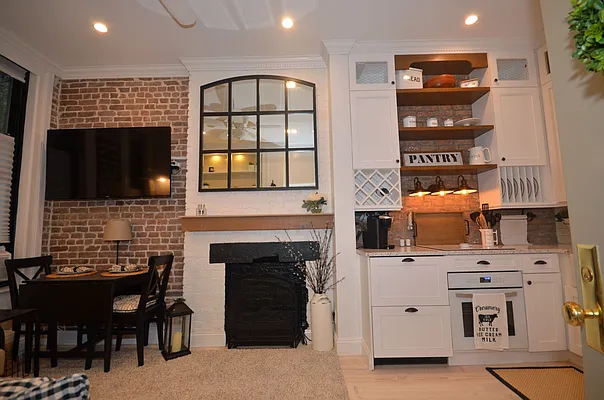 88 Horatio Street, Unit 1C Manhattan, NY 10014 - Photo 3 of 9 a living room with furniture fireplace and flat screen tv