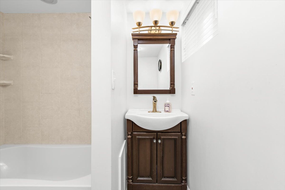 12712 Atherton Drive Silver Spring, MD 20906 - Photo 28 of 40 a bathroom with a sink a vanity and a bathtub
