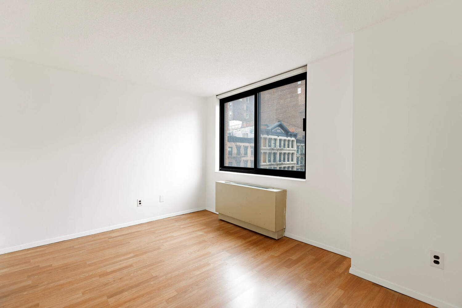 376 Broadway, Unit 6F Manhattan, NY 10013 - Photo 6 of 17 an empty room with wooden floor and windows