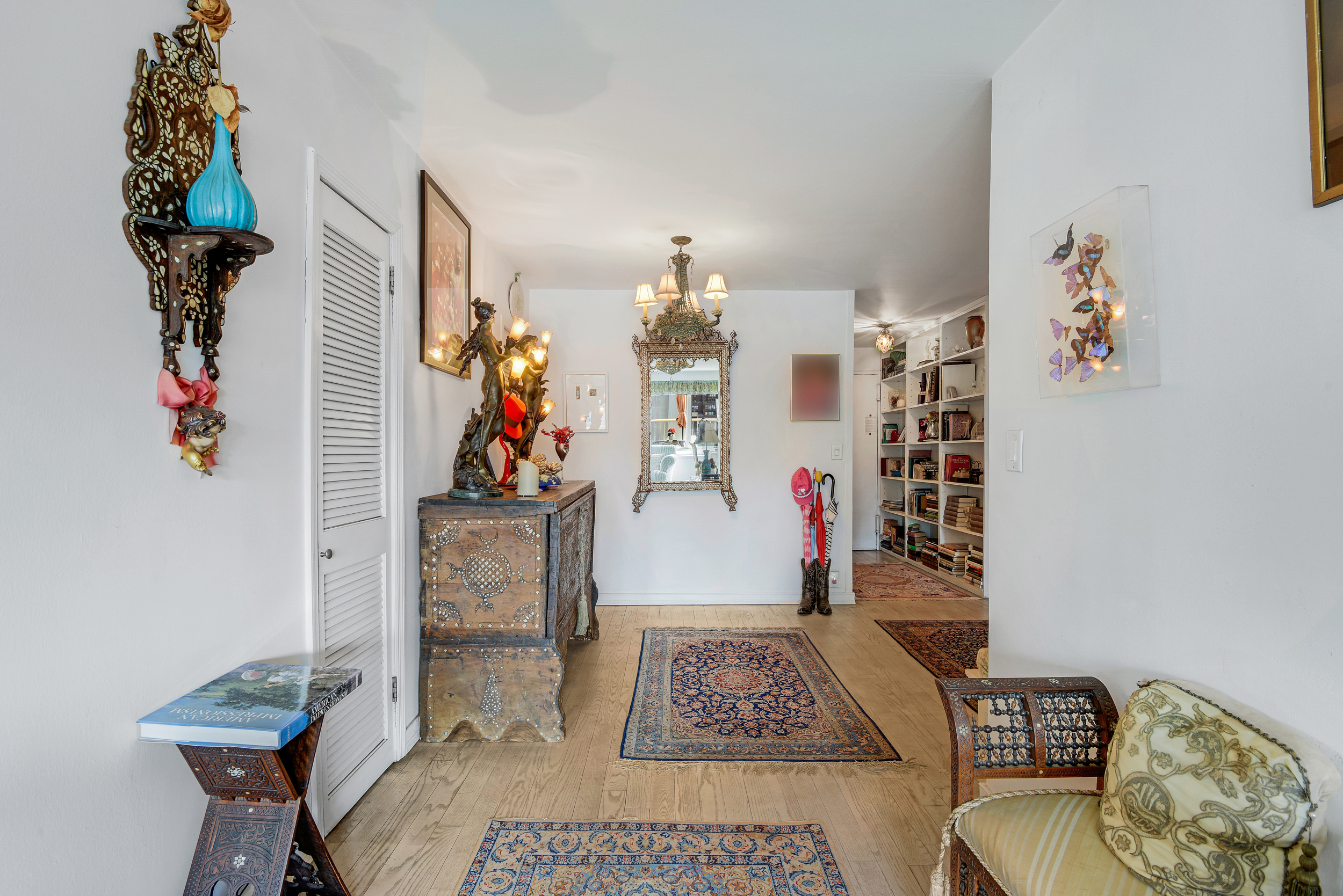 305 East 24th Street, Unit 18C Manhattan, NY 10010 - Photo 6 of 13 a living room with furniture and a chandelier