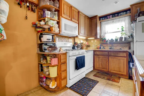 a kitchen with stainless steel appliances a stove a sink and a microwave