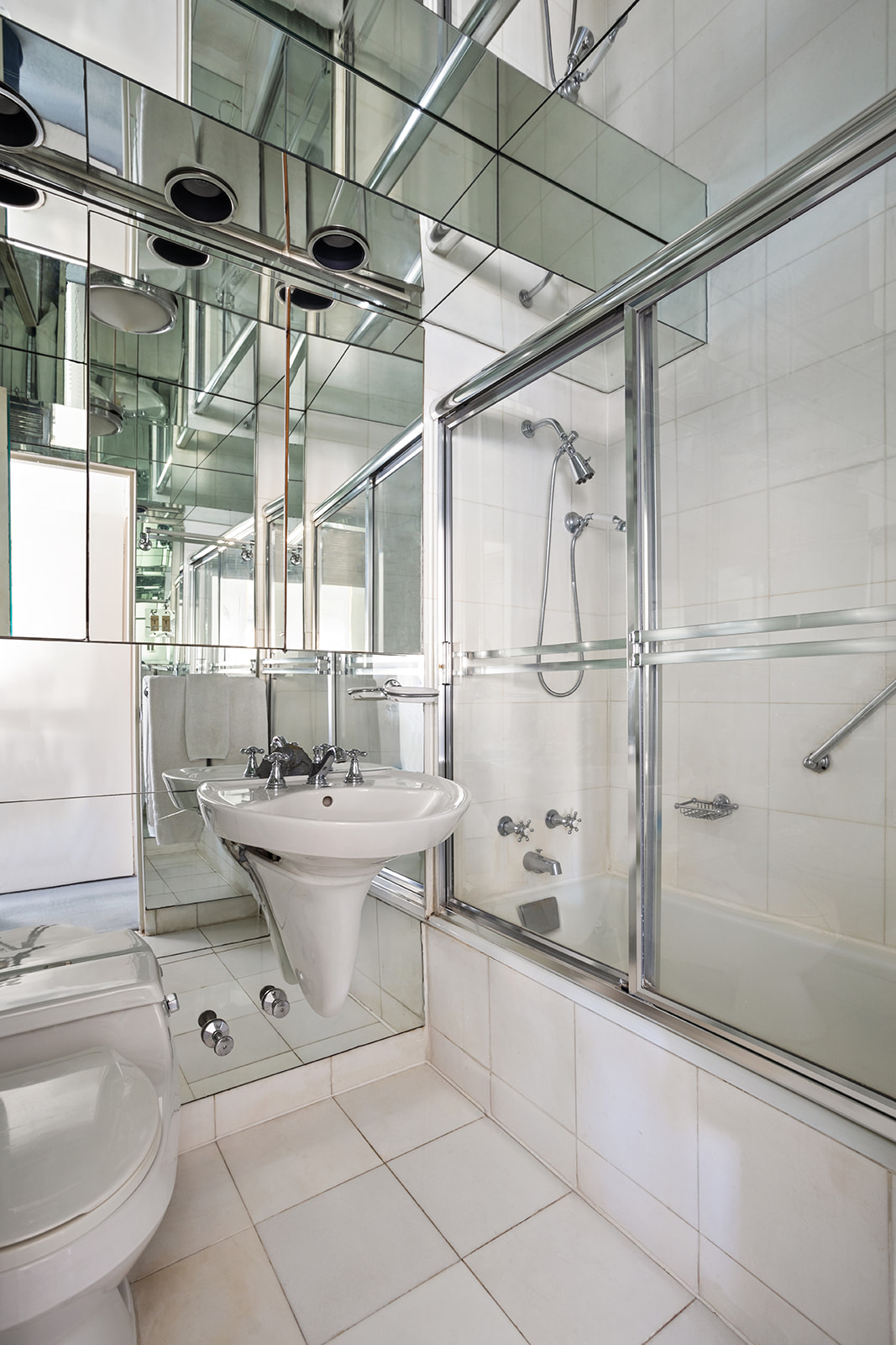 50 East 79th Street, Unit 12B Manhattan, NY 10075 - Photo 8 of 13 a bathroom with a sink toilet and shower