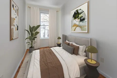 a bedroom with bed and painting on the wall