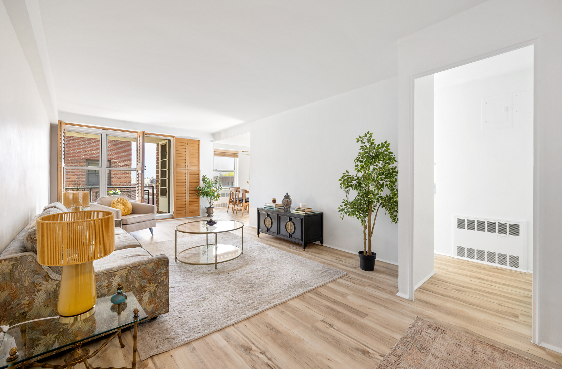 35-50 85th Street, Unit 9E Queens, NY 11372 - Photo 2 of 13 a living room with furniture and a potted plant