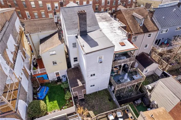 an aerial view of a house with a yard and furniture