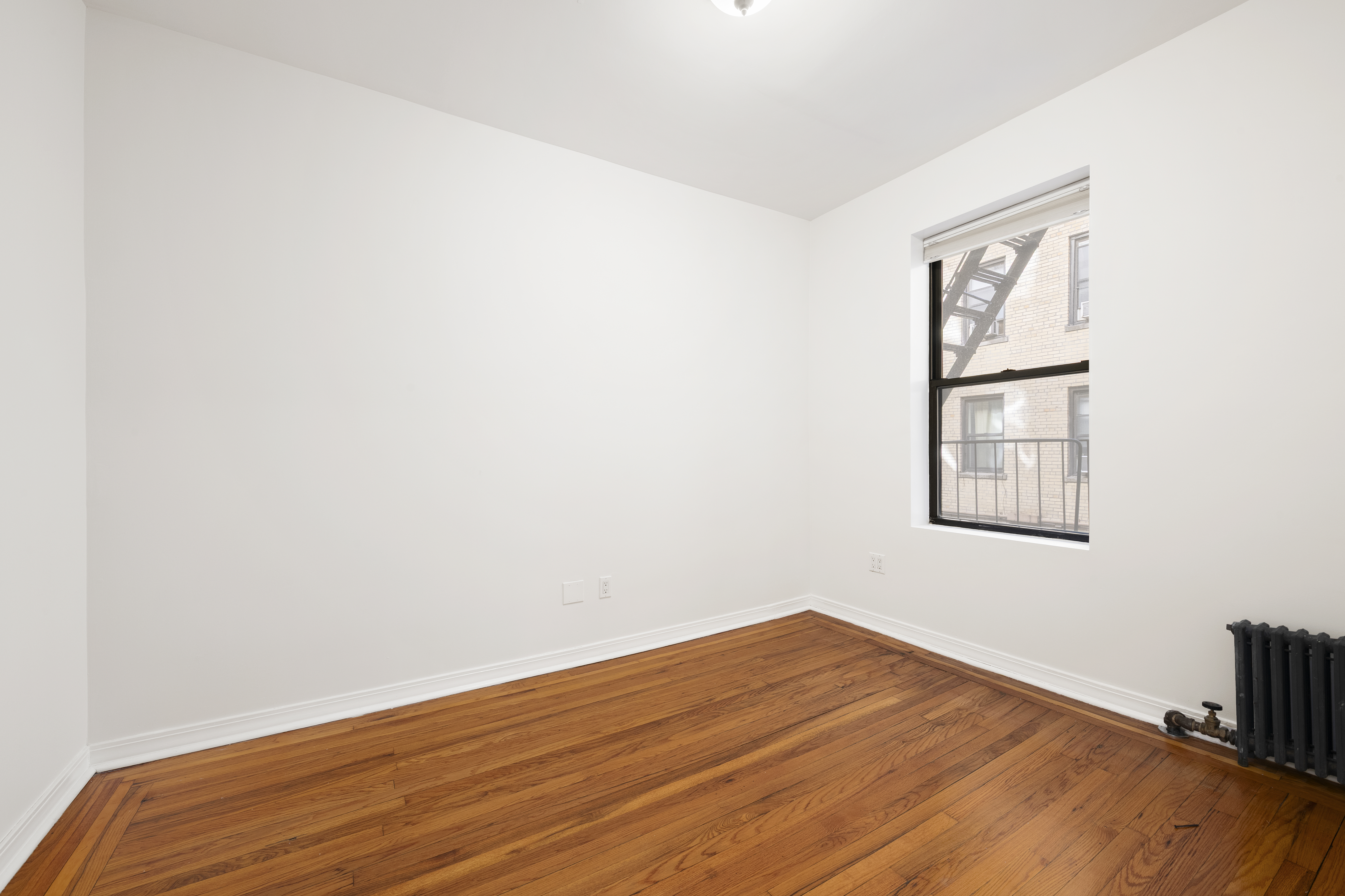 67 Morton Street, Unit 2A Manhattan, NY 10014 - Photo 7 of 10 a view of a big room with wooden floor and a window