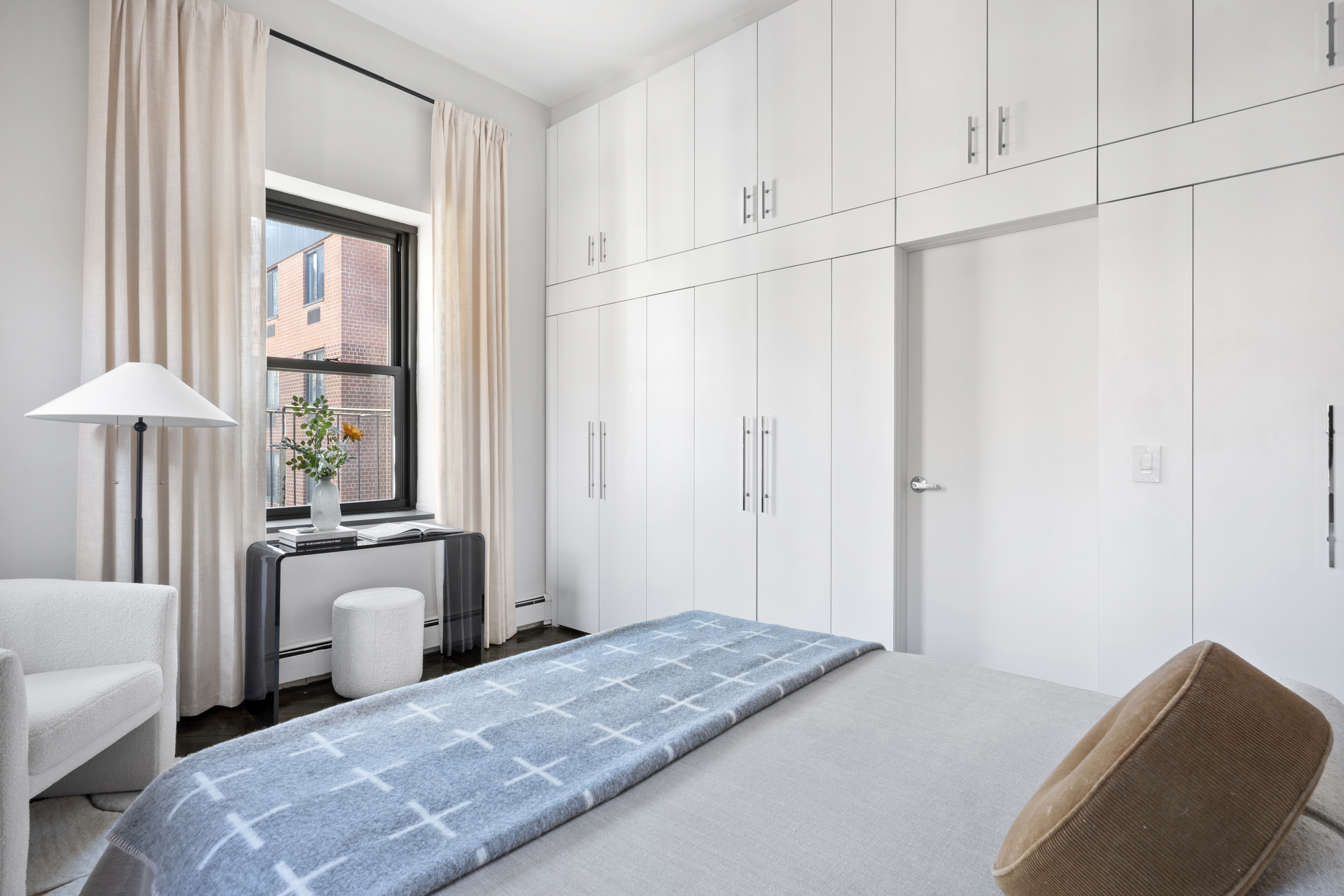 454 West 46th Street, Unit 5CS Manhattan, NY 10036 - Photo 8 of 25 a bedroom with a bed and a chandelier