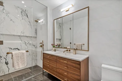a bathroom with a sink double vanity and a mirror