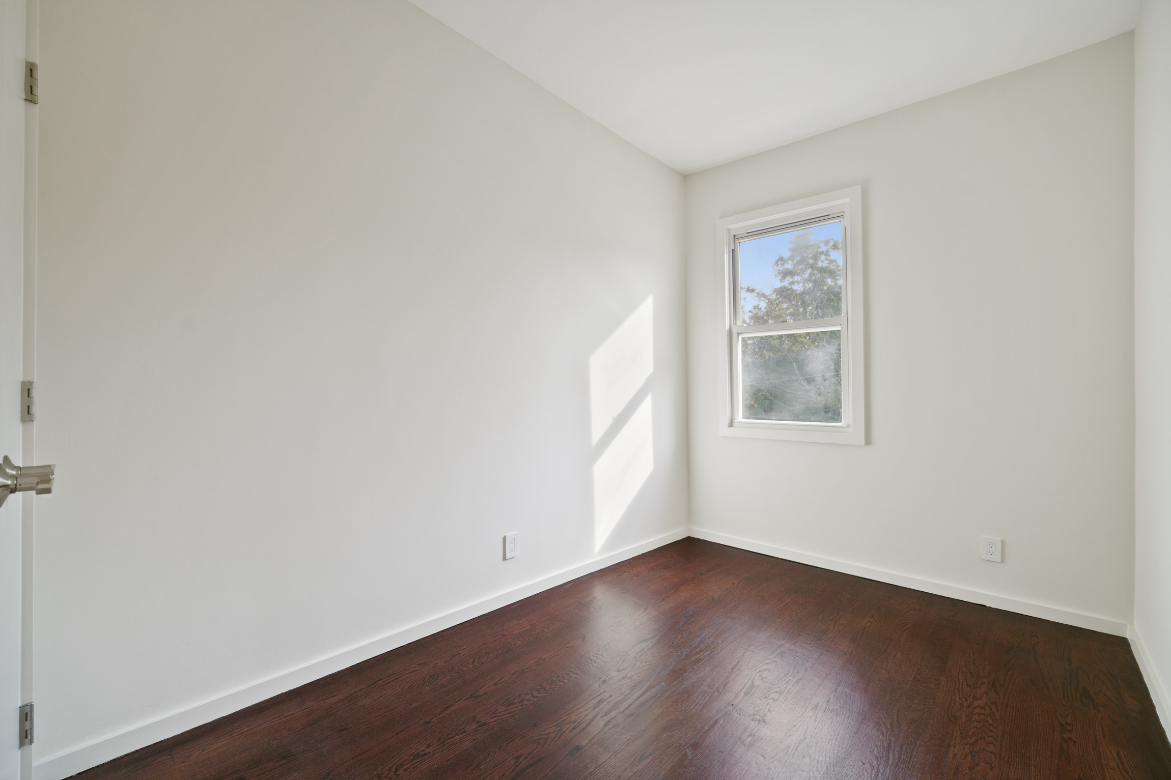 441 Metropolitan Avenue, Unit 1 Brooklyn, NY 11211 - Photo 9 of 11 an empty room with wooden floor and windows