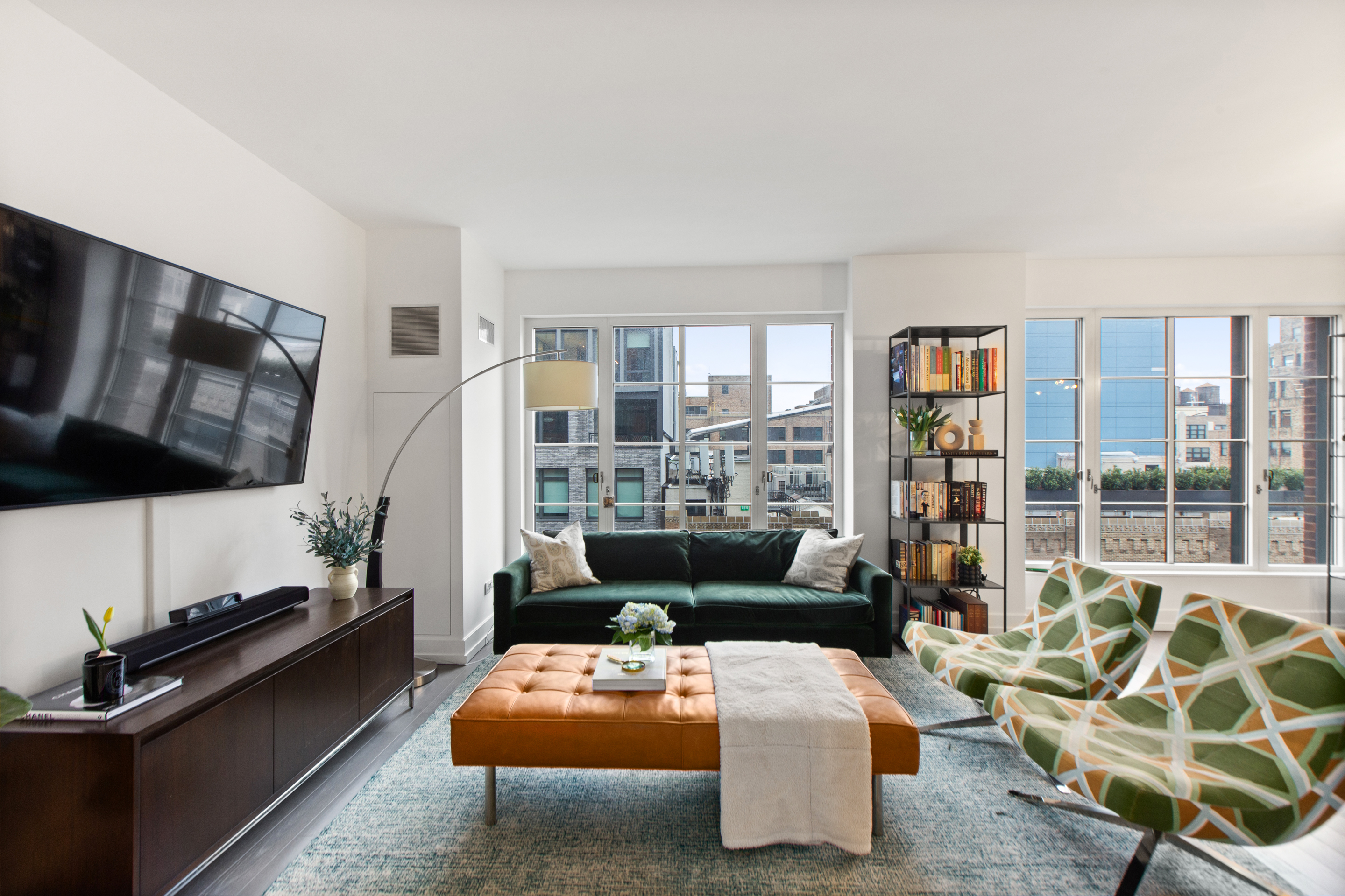70 Charlton Street, Unit 16C Manhattan, NY 10014 - Photo 4 of 31 a living room with furniture fireplace and a flat screen tv