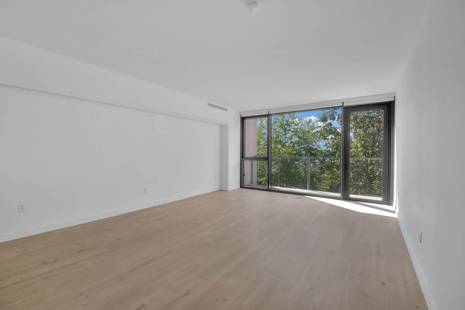 a bedroom with bed and a large window
