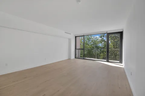 a bedroom with bed and a large window