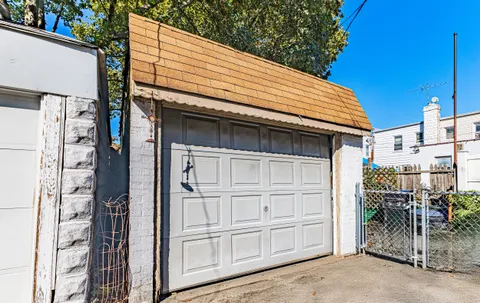 a view of a house with a window and potted plants