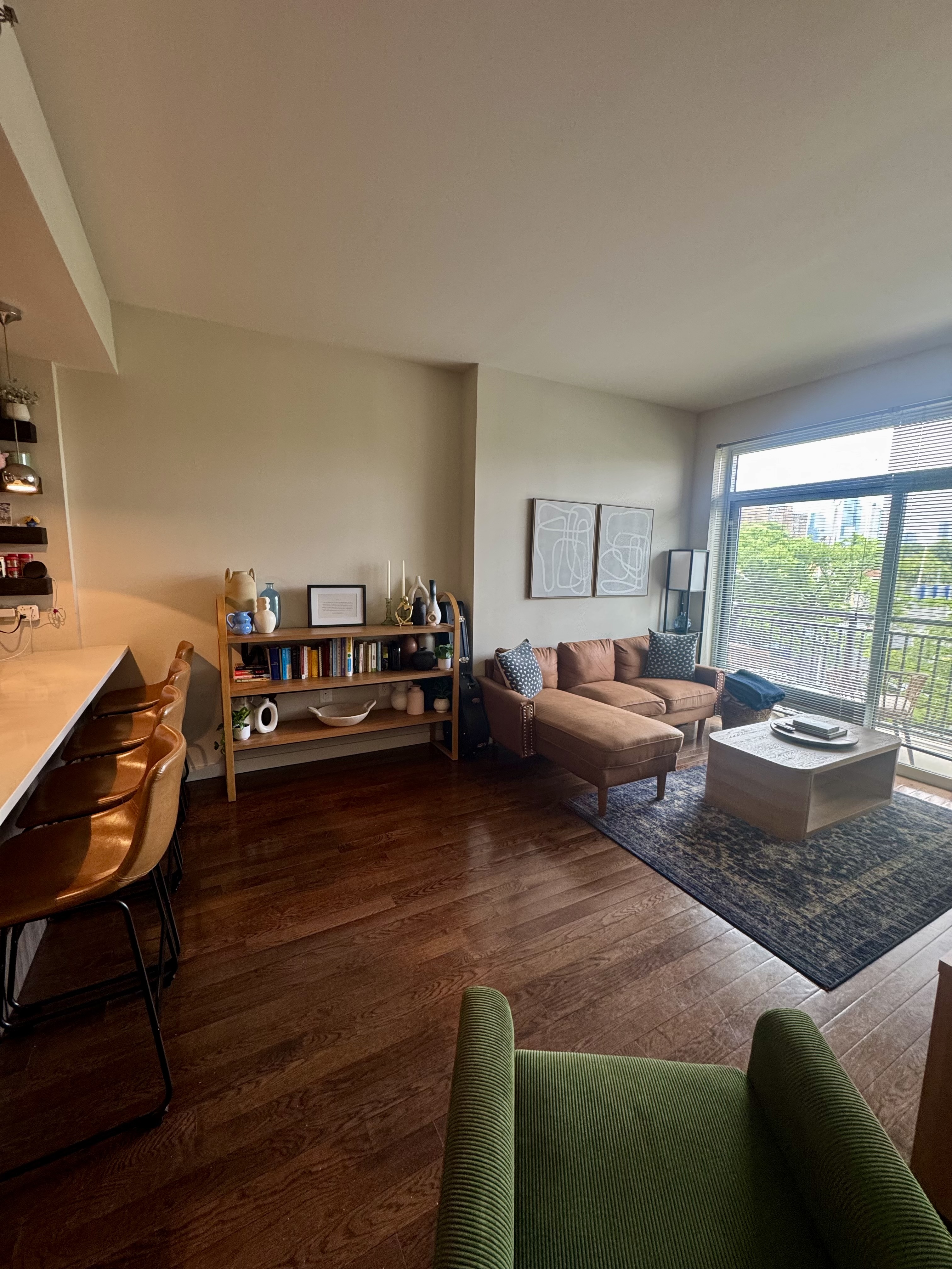 a living room with furniture wooden floor and a large window