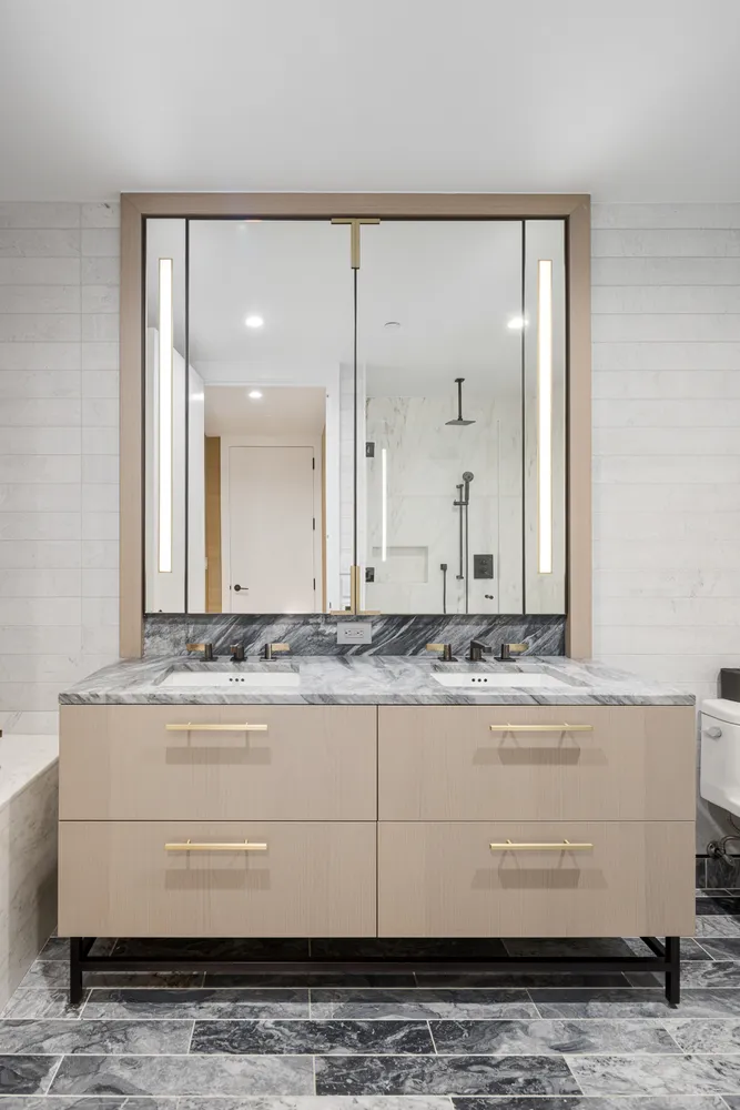a view of bathroom with mirror and vanity