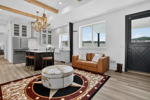 a living room with furniture and wooden floor
