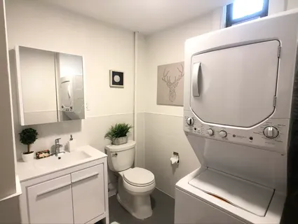 a white toilet sitting next to a bathroom sink