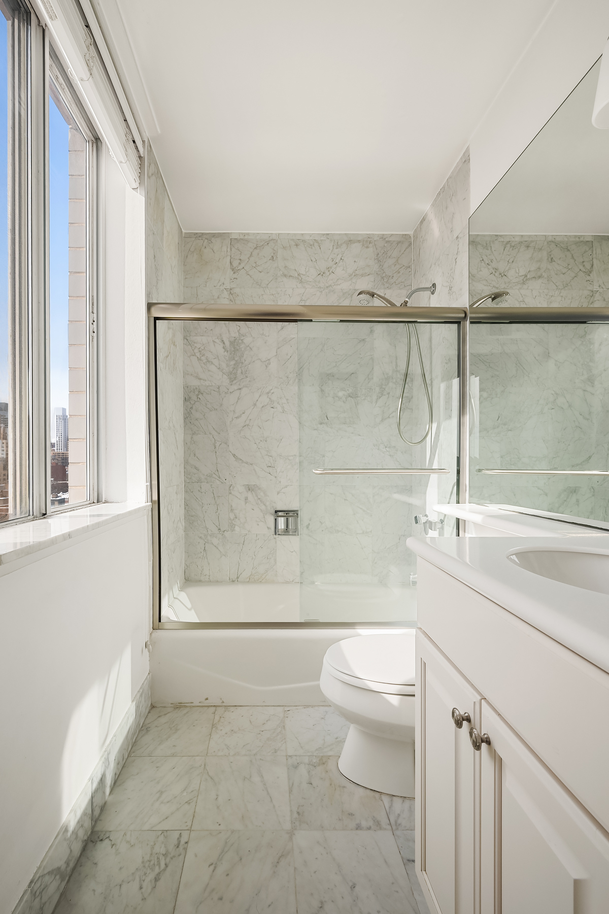 515 East 79th Street, Unit 15A Manhattan, NY 10075 - Photo 9 of 26 a bathroom with a toilet a sink and shower