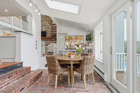 a kitchen with stainless steel appliances granite countertop a stove top oven a sink and a refrigerator