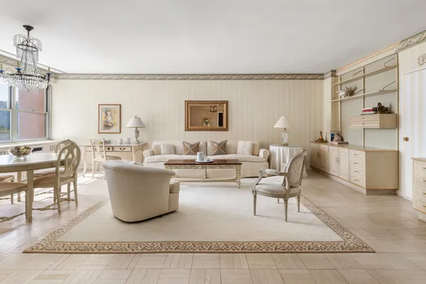 a living room with lots of furniture and a painting on the wall