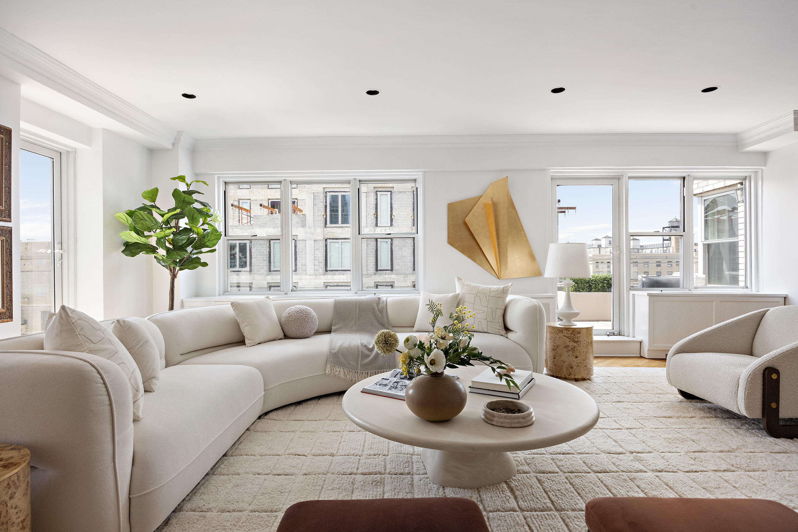 40 East 84th Street, Unit 17A Manhattan, NY 10028 - Photo 3 of 16 a living room with furniture and a large window