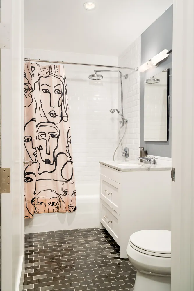 a bathroom with a shower a sink and a toilet