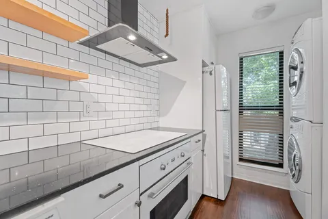 a bathroom with a granite countertop sink and a shower