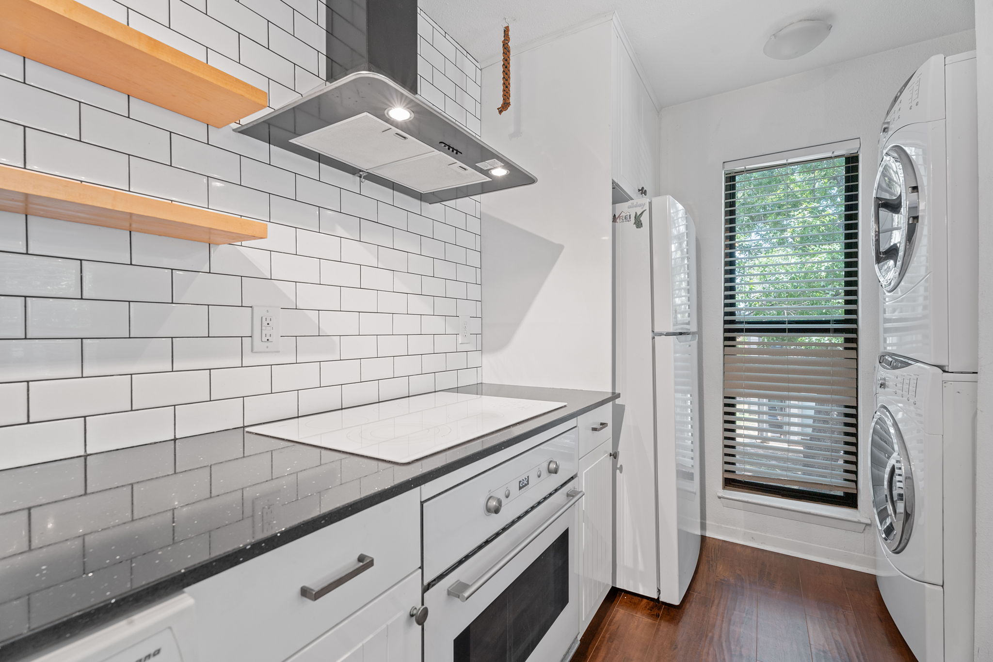 1510 West N Loop Boulevard, Unit 424 Austin, TX 78756 - Photo 8 of 25 a bathroom with a granite countertop sink and a shower