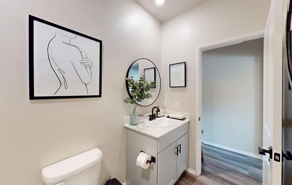 a living room with furniture a table and wooden floor