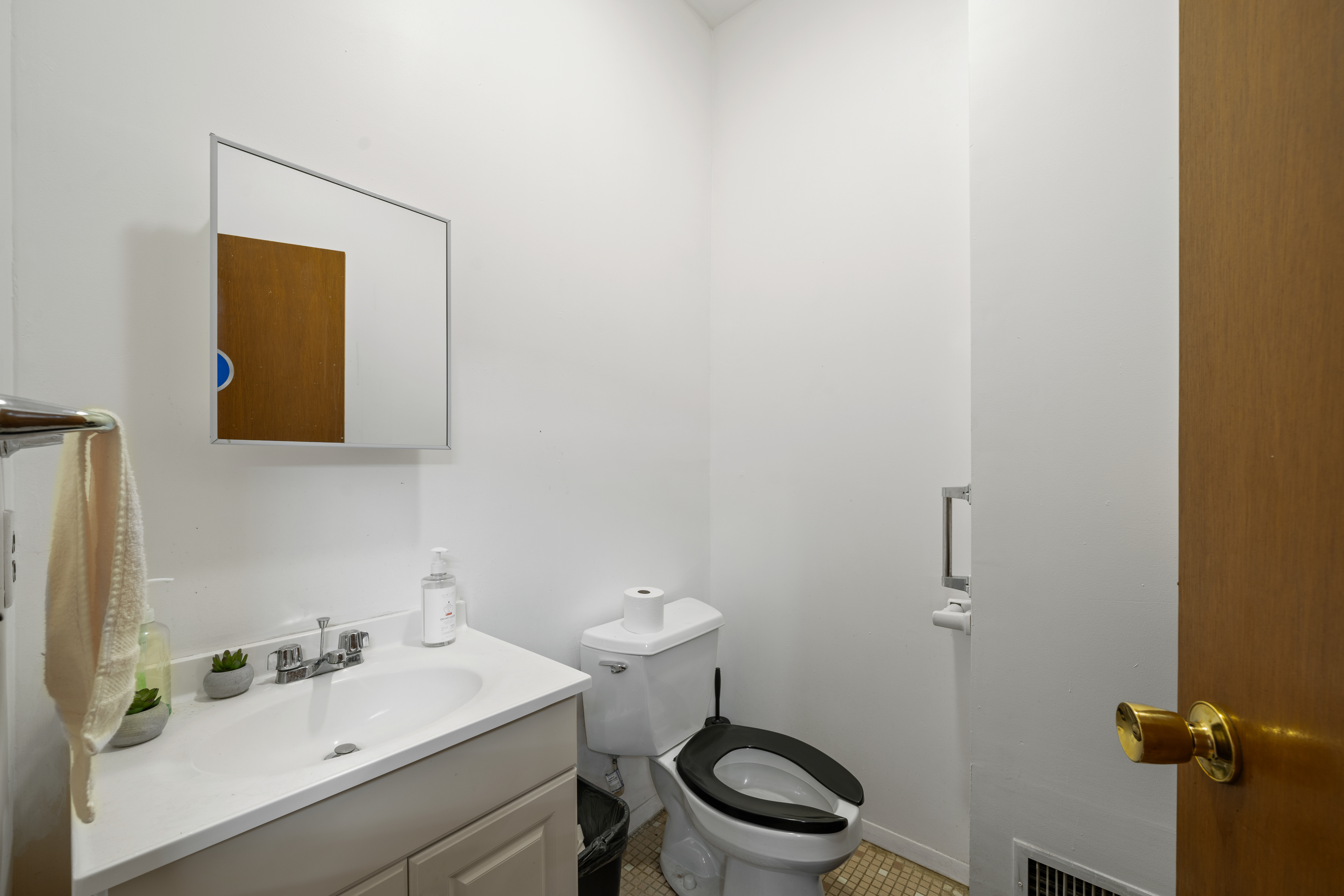 162 Mallory Avenue Jersey City, NJ 07304 - Photo 8 of 29 a bathroom with a toilet a sink and mirror