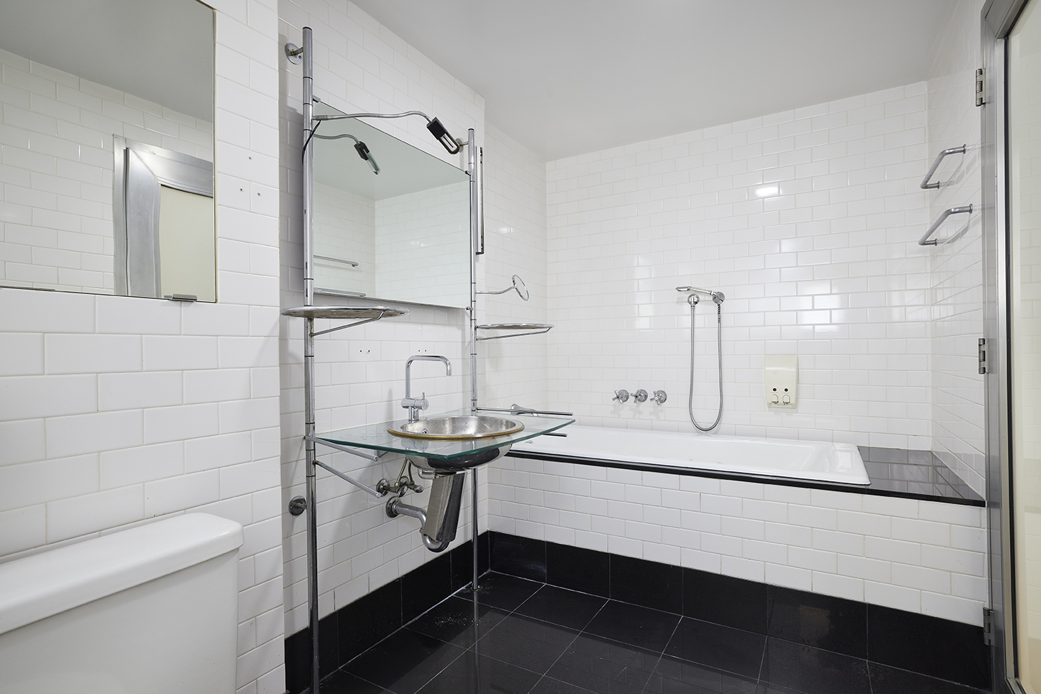 250 Mercer Street, Unit C603 Manhattan, NY 10012 - Photo 9 of 10 a bathroom with a sink a toilet and shower