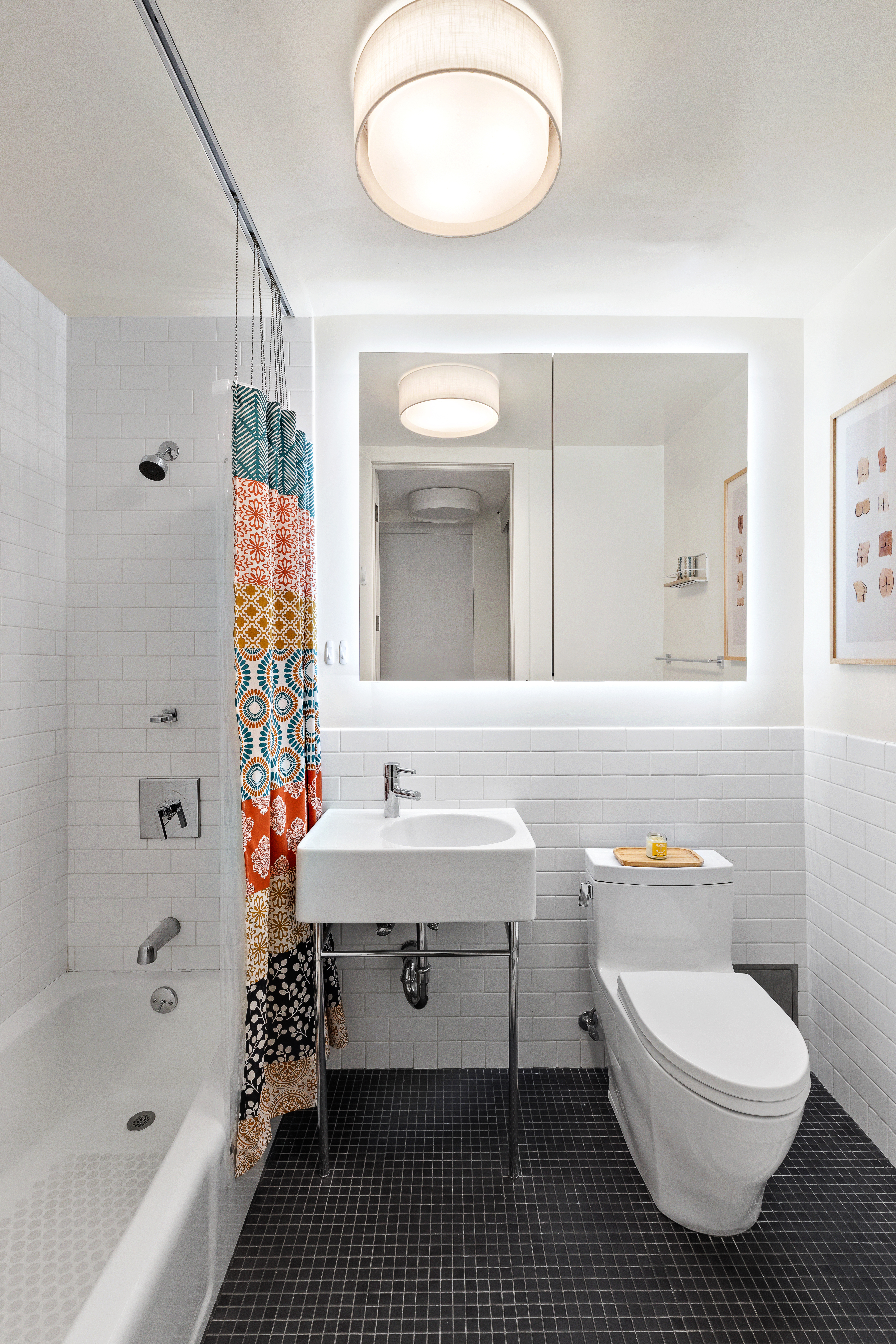 85 8th Avenue, Unit 5H Manhattan, NY 10011 - Photo 6 of 7 a bathroom with a sink a toilet and a bathtub