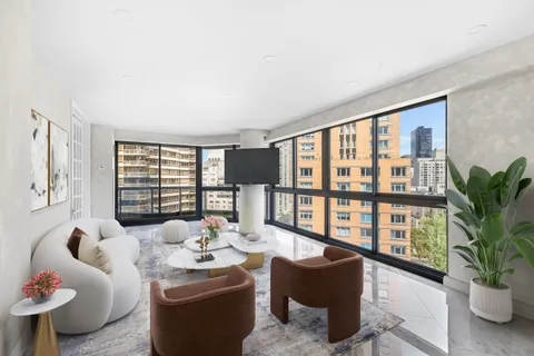 a living room with furniture and a potted plant