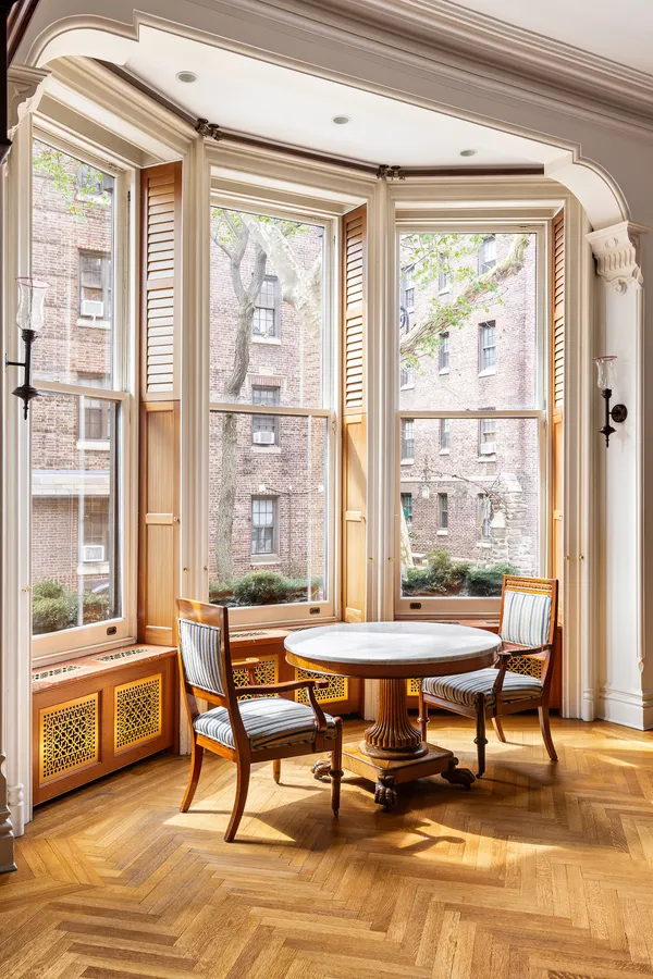 a living room with furniture a rug and a fireplace